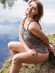 Yelena strips by the river baring her curvy hips and big tits.